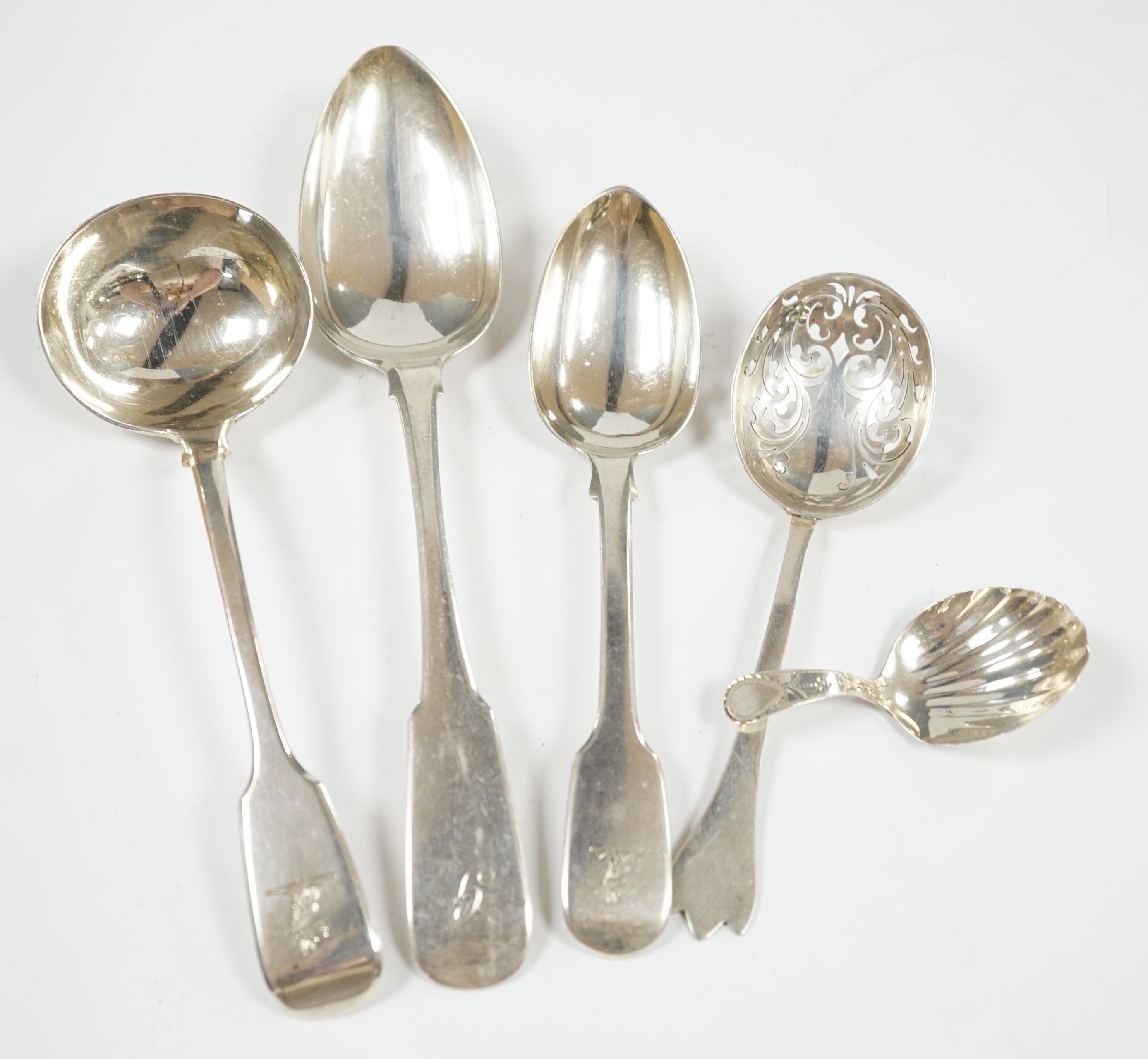 A quantity of assorted mainly 19th century silver flatware, including sauce ladles, table spoons, caddy spoon and sugar nips, various dates, patterns and makers, 59.4oz. Condition - poor to fair